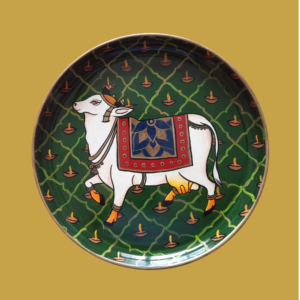Beautiful Kamadhenu: Green Hand Painted Wall Plate with Cow & Diya on it - By Sanskruti Artz
